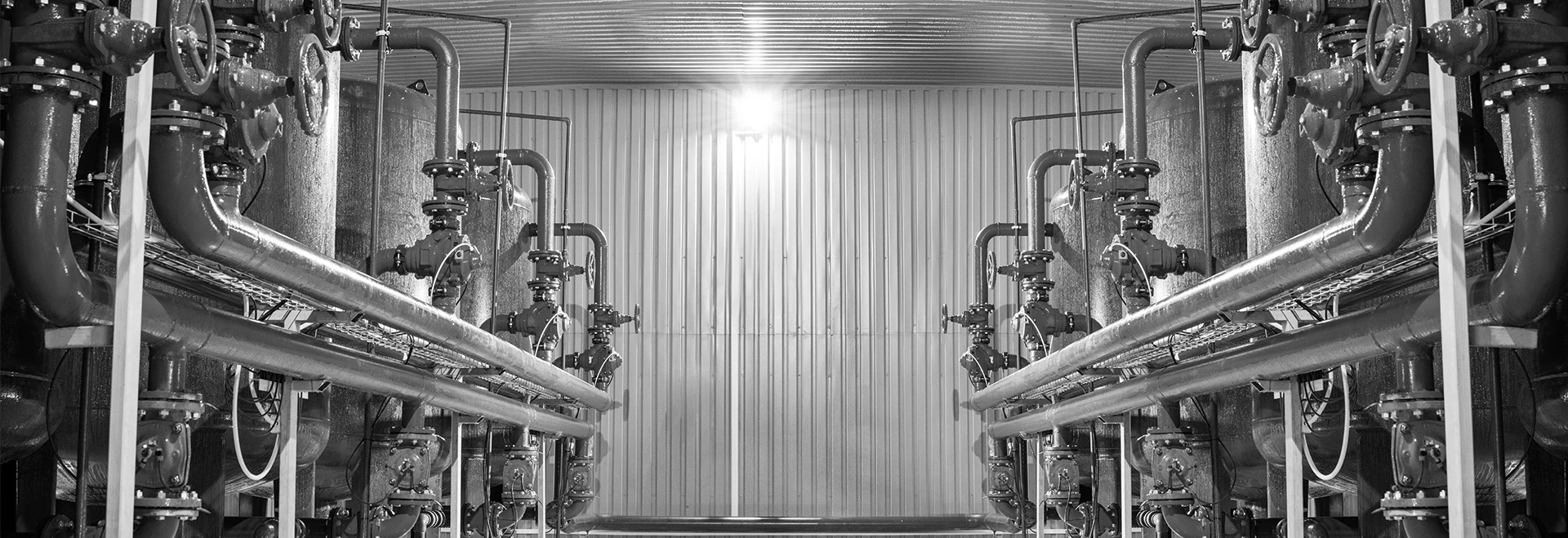 This is a picture of a factory with pumps and valves on either side