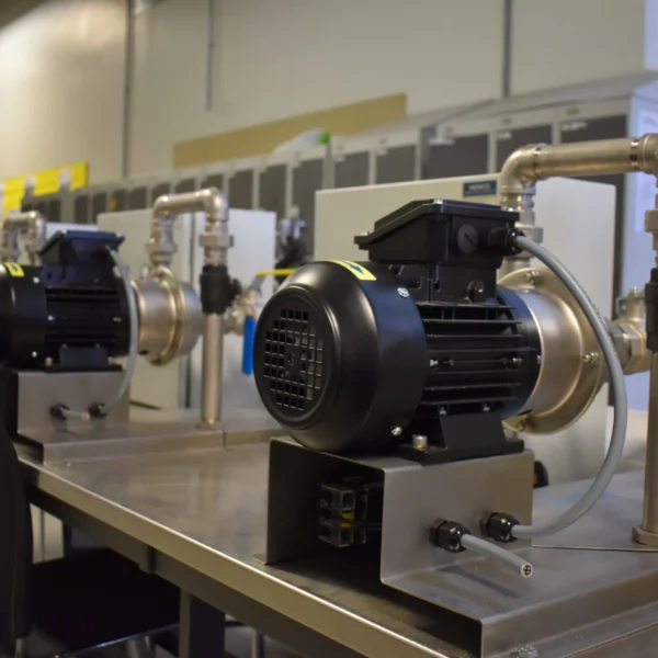 A close up picture of 4 smaller centrifugal pumps supplied by Tapflo to Fareham College for their trainee marine Engineer curriculum